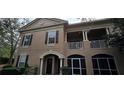 Attractive exterior view featuring a two-story facade with a cozy balcony and inviting arched entryway at 14214 Fredricksburg Dr # 106, Orlando, FL 32837