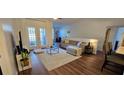 Bright living room boasts hardwood floors, modern furnishings, and sliding glass doors to the outdoor space at 14214 Fredricksburg Dr # 106, Orlando, FL 32837
