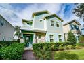 Two-story house with light blue siding, stone accents, and a landscaped front yard at 1432 Reunion Blvd, Reunion, FL 34747
