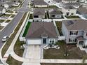 Aerial view of a single-Gathering home with a backyard and surrounding neighborhood at 1836 Delrose Rd, Kissimmee, FL 34744