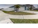 Neatly landscaped front yard with a white fence and concrete walkway at 1836 Delrose Rd, Kissimmee, FL 34744