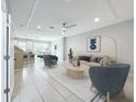 Bright living room with modern furnishings, recessed lighting, and view to open concept kitchen and dining area at 2559 Sedge Grass Way, Orlando, FL 32824
