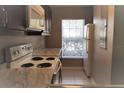 Compact kitchen with white appliances and updated countertops at 261 Autumn Ln # 4, Kissimmee, FL 34743