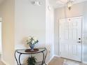 View of entryway with neutral paint, tile floors, and glass topped table at 2833 Oakwater Dr # 169, Kissimmee, FL 34747