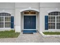 Elegant double front doors with blue paint and arched entryway at 3209 Eagle Watch Dr, Kissimmee, FL 34746