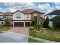 Two-story house with stone accents and a two-car garage at 3240 Preserve Dr, Orlando, FL 32824