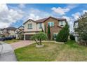 Two-story house with stone accents and a palm tree at 3240 Preserve Dr, Orlando, FL 32824