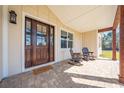Inviting front porch with rocking chairs and a brick patio at 3449 N Canoe Creek Rd, Kenansville, FL 34739
