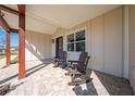 Inviting front porch with rocking chairs and a brick patio at 3449 N Canoe Creek Rd, Kenansville, FL 34739