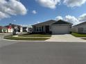 Lovely single-story home featuring a manicured lawn, classic design, and ample parking space at 401 Chayne Pl, St Cloud, FL 34771