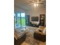 Spacious living room featuring sliding glass doors overlooking manicured lawn at 4033 Sunrise Ridge Blvd, Groveland, FL 34736