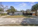 The front exterior of a single-story home features a minimalist design, complemented by a well-maintained lawn and landscaping at 45 S Edgemon Ave, Winter Springs, FL 32708