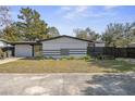A bright, single-story home boasts clean lines and simple landscaping, creating a welcoming curb appeal at 45 S Edgemon Ave, Winter Springs, FL 32708