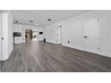 Spacious open-concept living room with stone fireplace, new gray laminate flooring, and ample natural light at 5438 San Luis Dr, Orlando, FL 32807