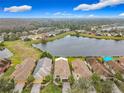 Aerial of homes with lake and conservation areas in the background at 669 Grand Canal Dr, Kissimmee, FL 34759