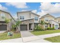 Modern home with stone exterior and palm trees in front at 771 Drop Shot Dr, Davenport, FL 33896