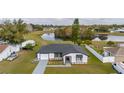Attractive single-story home with a well-manicured lawn and scenic waterfront view at 83 Alameda Dr, Kissimmee, FL 34743