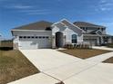 Two-story home with a gray exterior and a two-car garage at 835 Griffon Ave, Lake Alfred, FL 33850