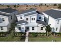 Modern home with a metal roof and light-stone exterior, in a residential area at 9234 Sommerset Hills Dr, Davenport, FL 33896