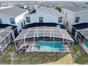 Screened-in pool and spa with a covered patio area at 9234 Sommerset Hills Dr, Davenport, FL 33896