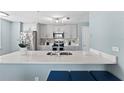 Modern kitchen with stainless steel appliances and white quartz countertops at 12209 Wild Iris Way # 110, Orlando, FL 32837