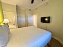 Bedroom featuring neutral carpet, a ceiling fan, and an entryway to the next room at 1350 Centre Court Ridge Dr # 401, Reunion, FL 34747