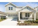 Beautiful two-story home with stone accents, a covered porch, and a two-car garage at 1503 August Gray Dr, Kissimmee, FL 34744