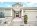House exterior showcasing a welcoming front entry and landscaping at 1944 Harvest Landing Cir, Lakeland, FL 33810