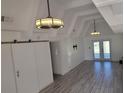 Bright living room with high ceilings, tile floors, and sliding barn door at 2201 Club Cir # 2201, Lake Wales, FL 33898