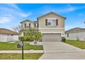 Inviting two-story home with a two-car garage and a well-manicured front lawn at 2849 Shelburne Way, St Cloud, FL 34772