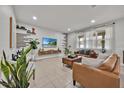 Cozy living room with modern decor, tile floors, and a comfortable seating area at 2849 Shelburne Way, St Cloud, FL 34772