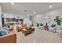 Bright, open-concept living room featuring stylish furniture, tile flooring, and plenty of natural light at 2849 Shelburne Way, St Cloud, FL 34772