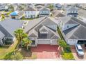 House with gray roof and red brick driveway, in a neighborhood at 3040 Cardillino Way, Kissimmee, FL 34741