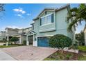 Inviting two-story home with a well-manicured lawn and a convenient two-car garage for easy parking at 350 Pendant Ct, Kissimmee, FL 34747