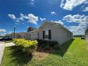 Side view of gray house with windows and landscaping at 4310 Seven Canyons Dr, Kissimmee, FL 34746