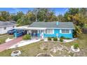 Light blue house with carport, landscaping, and a spacious yard at 505 Se Avenue G Se Ave # 1, Winter Haven, FL 33880