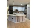 Modern kitchen with two-toned cabinets, a large island, and stainless steel appliances at 626 Baldwin Dr, Kissimmee, FL 34758