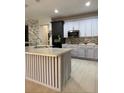 Modern kitchen with two-toned cabinets, a large island, and stainless steel appliances at 626 Baldwin Dr, Kissimmee, FL 34758