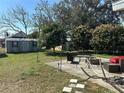 Large backyard with patio, fire pit, shed and plenty of space at 780 Avenue H Ne, Winter Haven, FL 33881