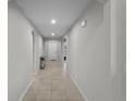 Bright hallway with tile flooring, neutral walls, and arched doorways offers a welcoming entrance at 826 Birch Hollow Dr, Apopka, FL 32703