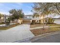 Inviting two-story home with a two-car garage, complemented by mature trees at 947 Emerald Green Ct, Kissimmee, FL 34746