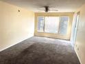 Image of a living room featuring wall-to-wall carpeting, a ceiling fan, and a window with blinds at 1091 S Hiawassee Rd # 216, Orlando, FL 32835