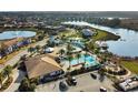 Community aerial view showcasing a large pool, waterslide, lakeside gazebo, and lounge seating at 113 Kenny Blvd, Haines City, FL 33844