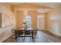 Dining room features high ceilings, hardwood floors, a modern chandelier, and natural light from large windows at 1145 Sugar Belt Dr, St Cloud, FL 34771