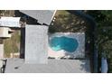 Aerial view of a kidney-shaped private swimming pool and a well-maintained backyard at 116 Hampden Rd, Winter Haven, FL 33884