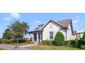 Charming single-story home with a well-manicured lawn and a welcoming front porch under a clear blue sky at 13432 Beebe Aly, Orlando, FL 32827