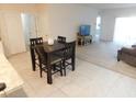 Bright living area with a dining table, sliding glass doors to the patio, and cozy seating at 1360 Berry Ln, Davenport, FL 33837