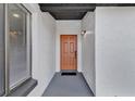 Inviting front porch with a brown door and a black matte at 1410 Rena Ln, Kissimmee, FL 34744