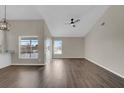 Spacious living room with new flooring and a ceiling fan at 1410 Rena Ln, Kissimmee, FL 34744
