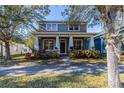 Beautiful two-story home featuring a classic design, covered porch, and professionally landscaped yard at 14637 Tanja King Blvd, Orlando, FL 32828